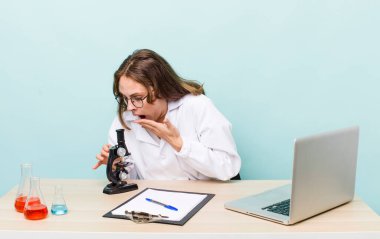 young physician woman with a microscophe. sciencist concept