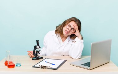 young physician woman with a microscophe. sciencist concept