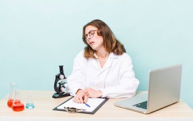 young physician woman with a microscophe. sciencist concept