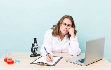 young physician woman with a microscophe. sciencist concept