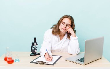young physician woman with a microscophe. sciencist concept