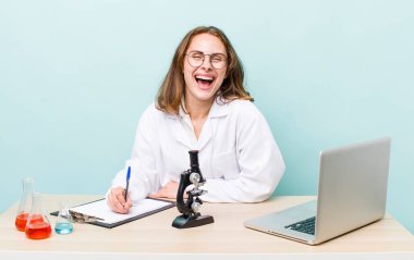 young physician woman with a microscophe. sciencist concept