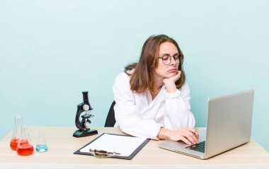 young physician woman with a microscophe. sciencist concept