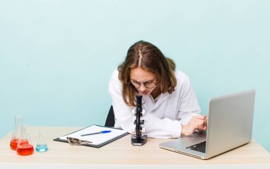 young physician woman with a microscophe. sciencist concept