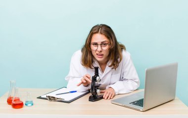 young physician woman with a microscophe. sciencist concept