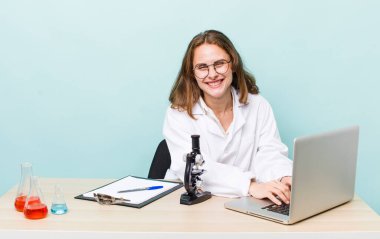 young physician woman with a microscophe. sciencist concept