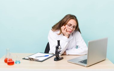 young physician woman with a microscophe. sciencist concept