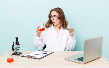 young physician woman with a microscophe. sciencist concept