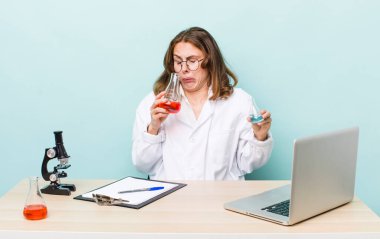 young physician woman with a microscophe. sciencist concept