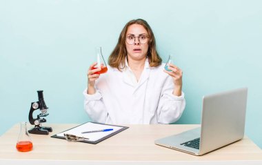 young physician woman with a microscophe. sciencist concept