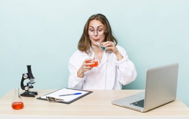 young physician woman with a microscophe. sciencist concept