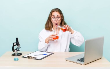 young physician woman with a microscophe. sciencist concept