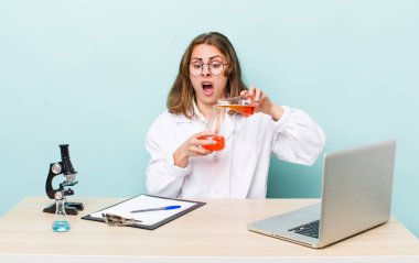 young physician woman with a microscophe. sciencist concept