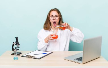 young physician woman with a microscophe. sciencist concept