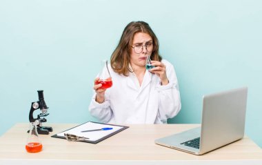 young physician woman with a microscophe. sciencist concept