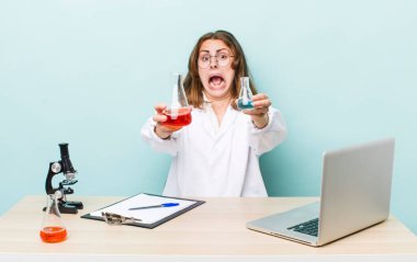 young physician woman with a microscophe. sciencist concept