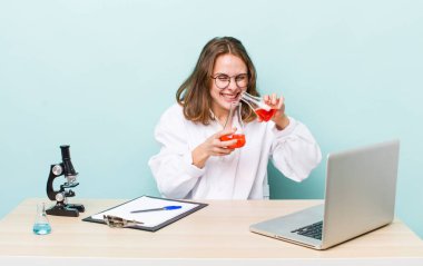 young physician woman with a microscophe. sciencist concept