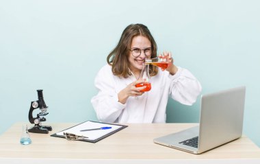 young physician woman with a microscophe. sciencist concept