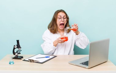 young physician woman with a microscophe. sciencist concept