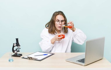 young physician woman with a microscophe. sciencist concept