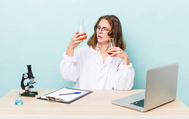 young physician woman with a microscophe. sciencist concept