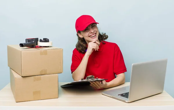 young adult pretty woman. company employee with boxes