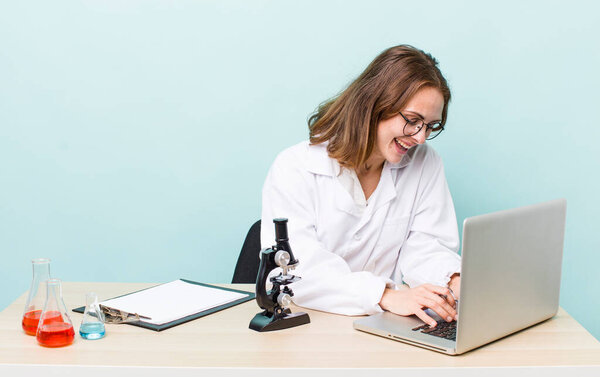 young physician woman with a microscophe. sciencist concept