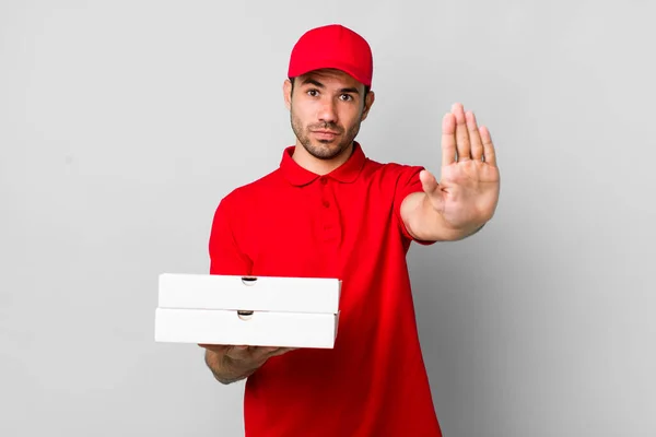 Young Adult Hispanic Man Looking Serious Showing Open Palm Making — 스톡 사진