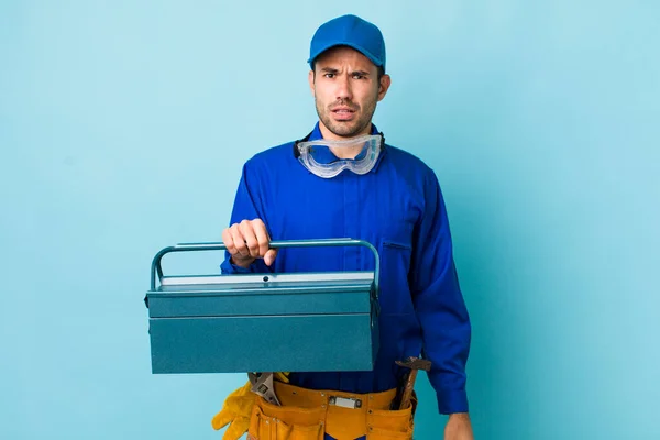 Young Adult Hispanic Man Feeling Puzzled Confused Toolbox Concept Plumber — Stockfoto