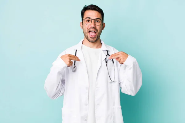 Young Adult Hispanic Man Feeling Happy Pointing Self Excited Physician — Stockfoto