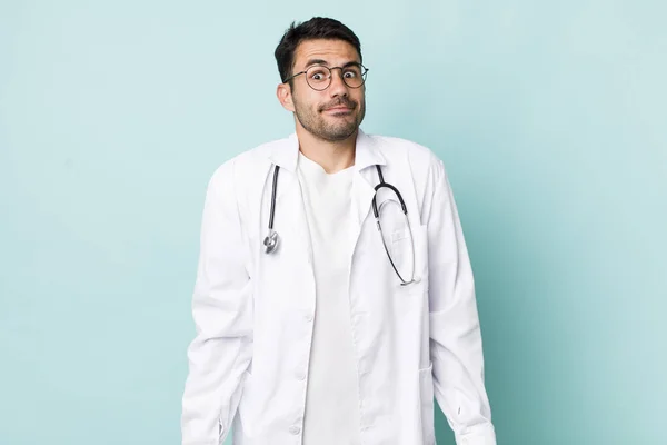 Young Adult Hispanic Man Shrugging Feeling Confused Uncertain Physician Concept — Stockfoto