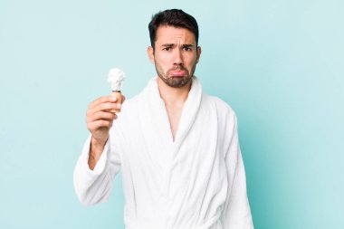 young adult hispanic man feeling sad and whiney with an unhappy look and crying. shaving concept