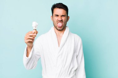 young adult hispanic man feeling disgusted and irritated and tongue out. shaving concept
