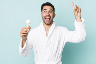 young adult hispanic man feeling like a happy and excited genius after realizing an idea. shaving concept