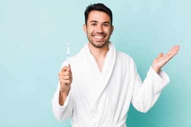 young adult hispanic man feeling happy, surprised realizing a solution or idea. toothbrush concept
