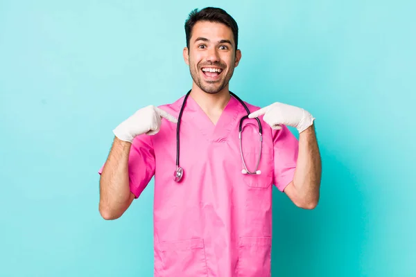 Young Adult Hispanic Man Feeling Happy Pointing Self Excited Veterinarian — Stock Photo, Image