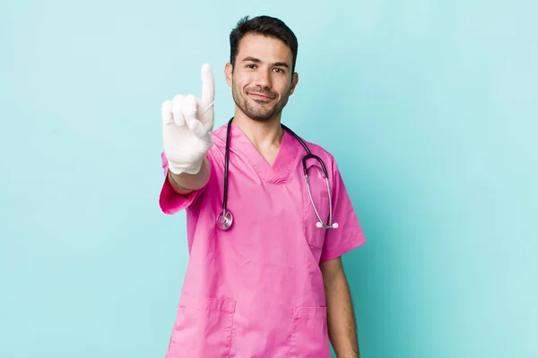 Young Adult Hispanic Man Smiling Looking Friendly Showing Number One — Stok fotoğraf