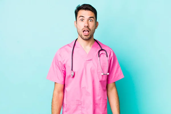 Young Adult Hispanic Man Looking Very Shocked Surprised Veterinarian Concept — 스톡 사진
