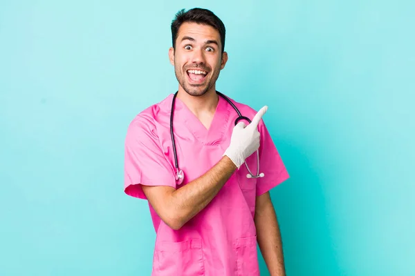Young Adult Hispanic Man Looking Excited Surprised Pointing Side Veterinarian —  Fotos de Stock