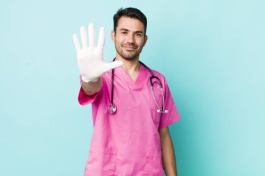 young adult hispanic man smiling and looking friendly, showing number five. veterinarian concept