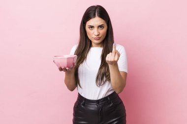 young pretty woman feeling angry, annoyed, rebellious and aggressive. empty bowl concept