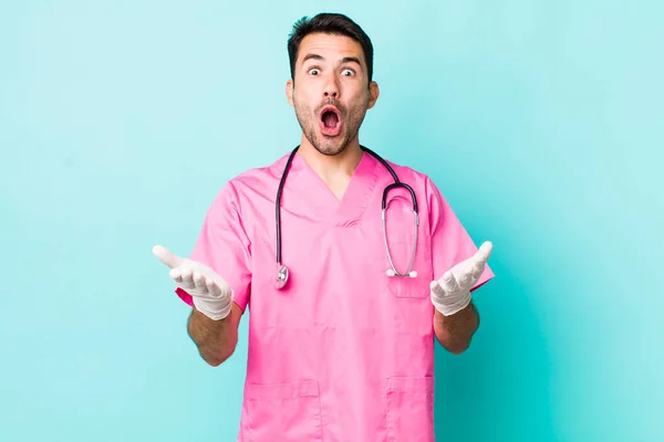 Young Adult Hispanic Man Amazed Shocked Astonished Unbelievable Surprise Veterinarian — Stockfoto