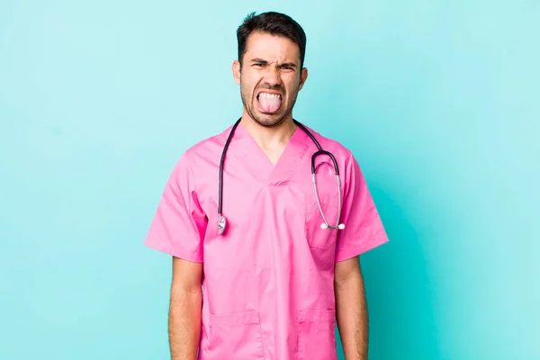 Young Adult Hispanic Man Feeling Disgusted Irritated Tongue Out Veterinarian — Fotografie, imagine de stoc