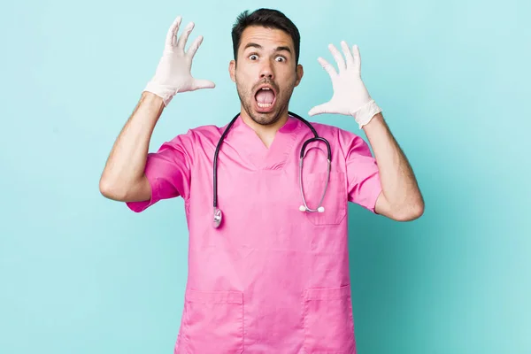 Young Adult Hispanic Man Screaming Hands Air Veterinarian Concept — Zdjęcie stockowe