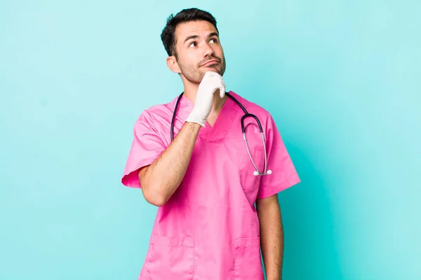 Young Adult Hispanic Man Thinking Feeling Doubtful Confused Veterinarian Concept — Stockfoto