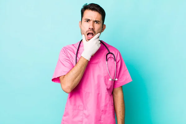 Young Adult Hispanic Man Mouth Eyes Wide Open Hand Chin — Stockfoto