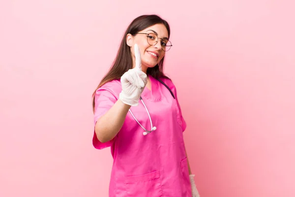 Young Pretty Woman Smiling Proudly Confidently Making Number One Veterinarian — Photo