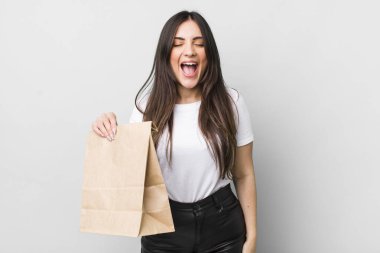 young pretty woman shouting aggressively, looking very angry. take away food concept