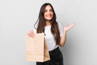 young pretty woman feeling happy, surprised realizing a solution or idea. take away food concept