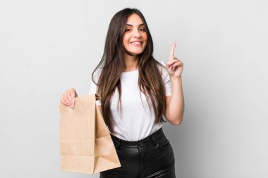 young pretty woman feeling like a happy and excited genius after realizing an idea. take away food concept